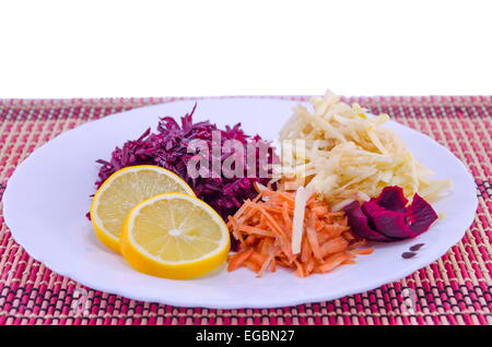 Grated carrots beet and apples on a white plate Stock Photo