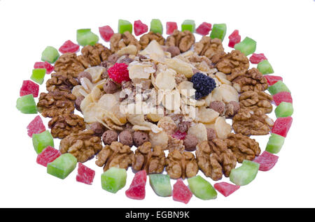 A pile of walnuts, muesli and dried mango and lime isolated on white background Stock Photo