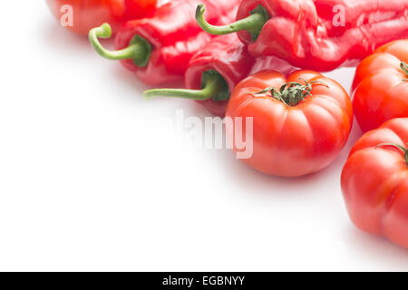 red tomatoes and peppers on white background Stock Photo