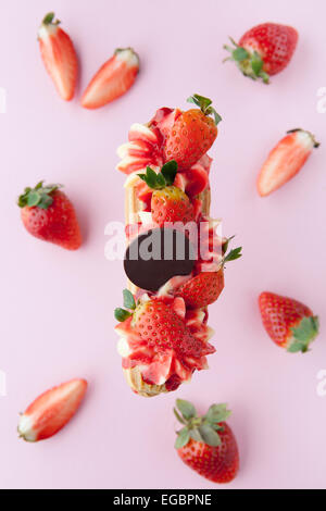 exquisite cream dessert eclair with fresh strawberry Stock Photo