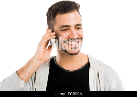 Happy young man talking on cell phone isolated on white background Stock Photo