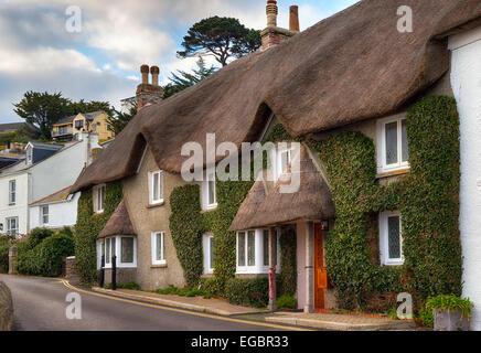 Pretty thatched cottages at the seaside town of St Mawes near Falmouth in Cornwall Stock Photo