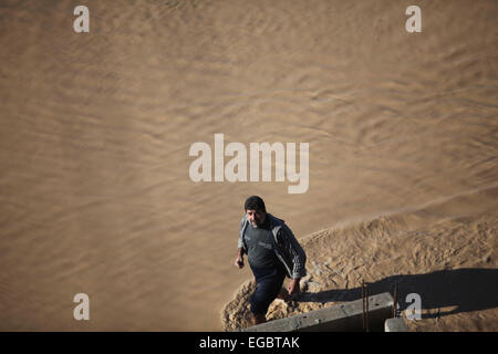 Gaza City, Gaza Strip, Palestinian Territory. 22nd Feb, 2015. A Palestinian Bedouin man makes his way despite the water in an area that is flooded after Israel opened the gates of a dam along its border with the Gaza Strip on February 22, 2015 in the village of al-Mughraqa, south of Gaza City. Palestinian authorities said the Israeli army opened the floodgates of a canal leading to central Gaza, causing the flooding of several Palestinian homes © Ashraf Amra/APA Images/ZUMA Wire/Alamy Live News Stock Photo