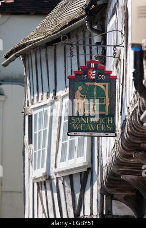 Replica 16th century sign over door of wood timber framed plaster house, '1500, Sandwich weavers' in the historical old town of Sandwich, in England. Stock Photo
