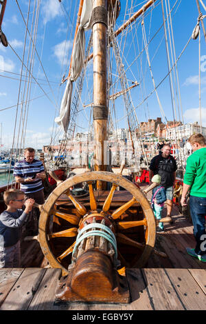 Replica Russian 1703 Frigate, Shtandart moored at Ramsgate. Deck view to the stern of the man-of-war with the ship's wheel and the mizzen mast. Stock Photo