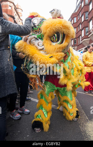 London, UK. 22nd February, 2015. A lion dancer receives a pat on the head from crowds gathered in and around Chinatown to celebrate the Year of the Sheep by watching the annual Chinese New Year Parade. Credit:  Stephen Chung/Alamy Live News Stock Photo