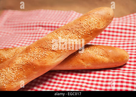 French bread isolated on checkered napkin Stock Photo