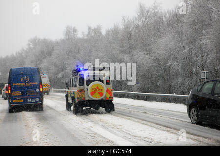 Luss, Scotland, UK. 22nd Feb, 2015. Police cars on the A82 north of Glasgow race on snowy and icy roads to an incident. Credit:  PictureScotland/Alamy Live News Stock Photo