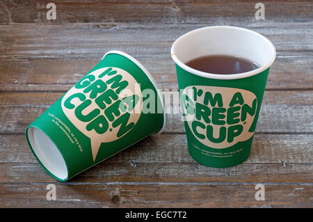 I'm a green cup printed on the front of 2 100% compostable cardboard cup which is kind to the environment. Two on a wooden tray Stock Photo