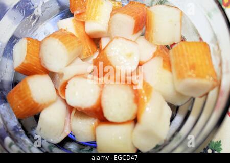 sticks of pulp crabs to pieces in glass bowl Stock Photo