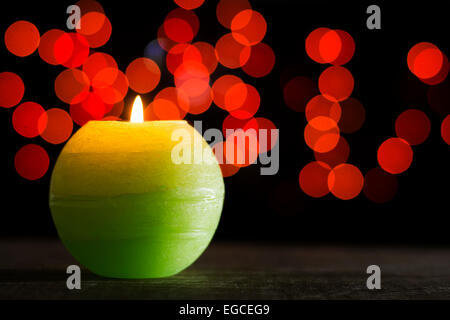 https://l450v.alamy.com/450v/egceg9/candle-shining-placed-on-wooden-background-with-red-bokeh-effect-egceg9.jpg