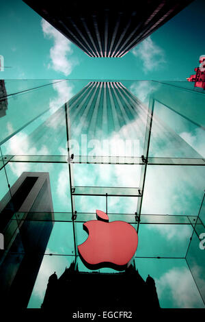 The Apple Logo, on the glass fronted Apple Store, surrounded by the high rise buildings of Manhattan, New York, USA. Stock Photo