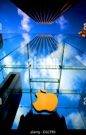 The Apple Logo, on the glass fronted Apple Store, surrounded by the high rise buildings of Manhattan, New York, USA. Stock Photo