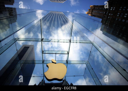 The Apple Logo, on the glass fronted Apple Store, surrounded by the high rise buildings of Manhattan, New York, USA. Stock Photo