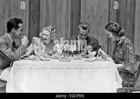 1930s 1940s TWO COUPLES EATING DINING CLUB RESTAURANT LAUGHING Stock Photo