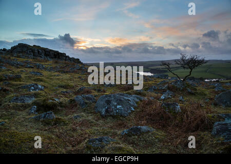 Tregarrick tor as the sun is going down over siblyback lake Stock Photo
