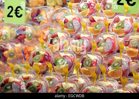 Brightly colorful fresh healthy fruit salads for sale food market, La Rambas, Barcelona, Spain Stock Photo