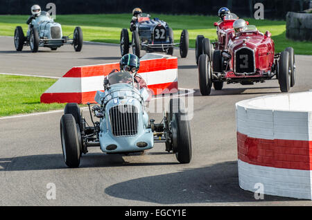 Reg Parnell MG K3 1.1 litre supercharged 6 cylinder race car, built in 1936 leading a gaggle of classic vintage racing cars at Goodwood Revival Stock Photo