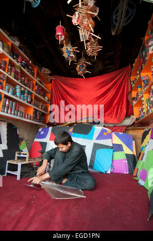 10 year old Jamil makes kites in his father's shop. Stock Photo