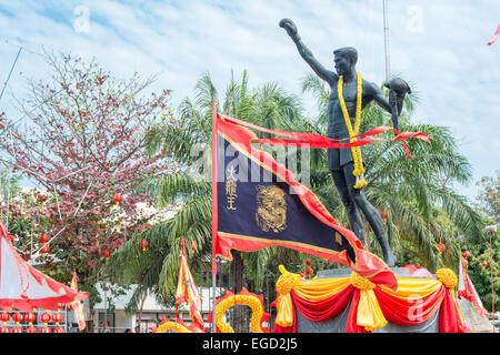 Statue of a Thai boxer decorated for Chinese New Year celebrations in Hua Hin, Thailand Stock Photo