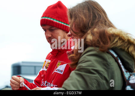 Montmelo, Spain. 21st Feb, 2015. Sebastian Vettel (Scuderia Ferrari) sign some autogramms to the fans, during day three of Formula One Winter Testing at Circuit de Catalunya (Barcelona) on February 21, 2015 in Montmelo, Spain. Foto: S.Lau © dpa/Alamy Live News Stock Photo