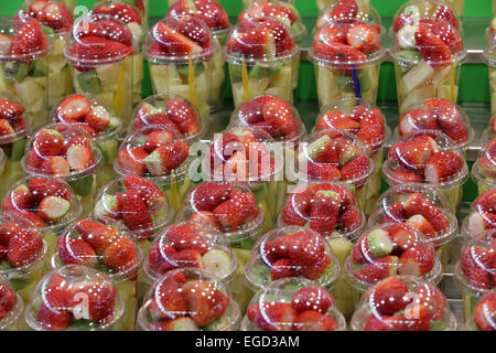Brightly colorful fresh healthy fruit salads for sale food Boqueria Market, La Ramba, Barcelona, Spain Stock Photo