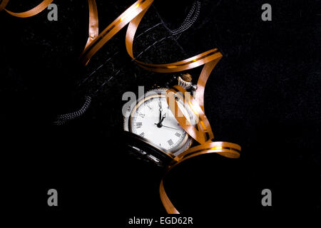 Waiting to party concept - the pocket watch showing five minutes to twelve with decoration ribbon (New Years concept) Stock Photo