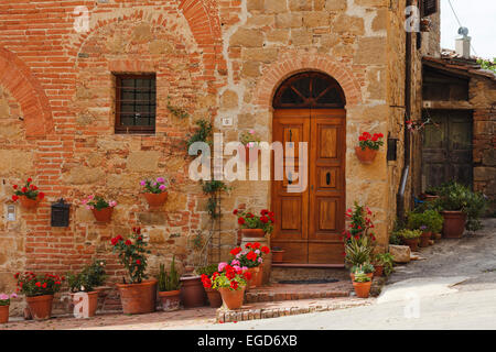 Door surrounded by flowers in the ancient village of Monticchiello, Orcia valley, Val d'Orcia, UNESCO World Heritage Site, province of Siena, Tuscany, Italy, Europe Stock Photo