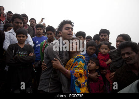 Manikgonj, Dhaka, Bangladesh. 23rd Feb, 2015. Relatives of passengers aboard the sunken ferry wait for their missing ones as they watch a rescue operation on the banks of the River Padma Sunday after being hit by a cargo vessel at Paturia, in Manikganj district, about 80 kilometers northwest of Dhaka, Bangladesh, Monday, Feb. 23, 2015. Credit:  Suvra Kanti Das/ZUMA Wire/ZUMAPRESS.com/Alamy Live News Stock Photo