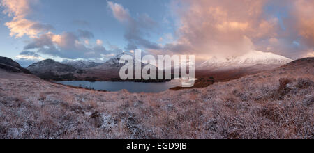 Vast panorama of the snow-covered North West Highlands overlooking the summits of Sgurr Dubh, Liathach and Beinn Eighe (from left) over the Loch Clair in Winter at sunrise, Torridon, Scotland, United Kingdom Stock Photo