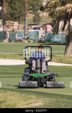 Greenkeeper Cutting The Green at La Marquesa Golf and Country Club Quesada Spain Stock Photo
