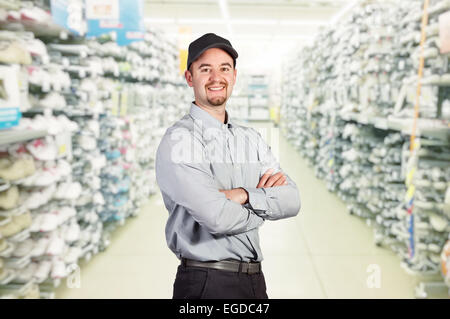 smiling worker in big sport shop Stock Photo