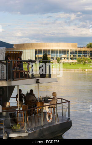 Cafe Lido on the river Danube and the Bruckner concert hall, Linz, Upper Austria, Austria Stock Photo