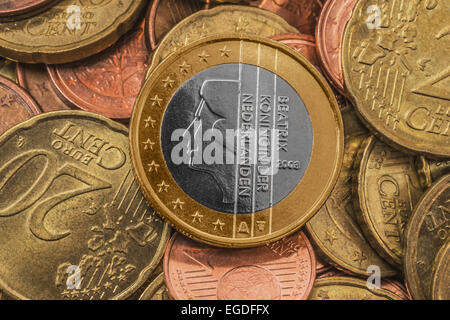Many Euro coins, on top is a 1 Euro coin from the Netherlands Stock Photo