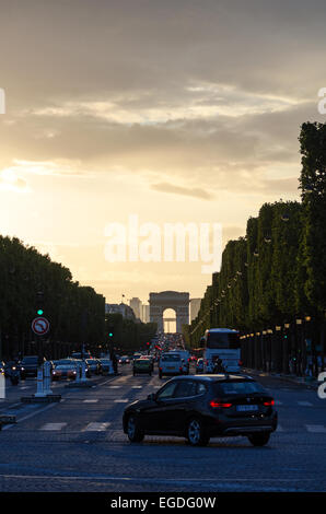Looking up the Avenue des Champs-Élysées from the Place de la Concorde toward the Arc de Triomphe at sunset, Paris, France. Stock Photo