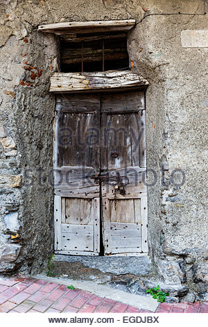 ancient wooden doorway in European village Stock Photo