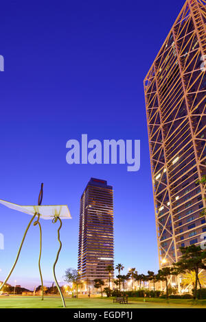 Modern sculpture in front of twin towers Hotel Arts and Mapfre Tower, illuminated at night, Olympic village, Barceloneta, Barcelona, Catalonia, Spain Stock Photo