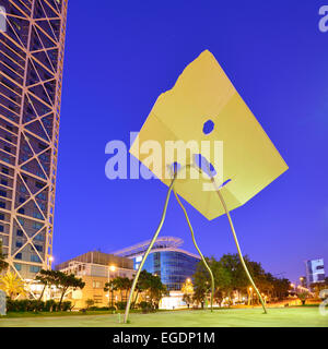 Modern sculpture in front of twin towers Hotel Arts and Mapfre Tower, illuminated at night, Olympic village, Barceloneta, Barcelona, Catalonia, Spain Stock Photo
