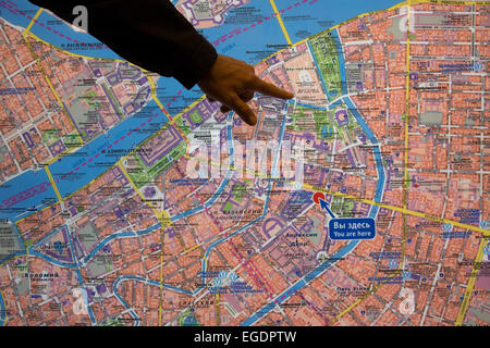 Man's hand pointing to an illuminated city map, St. Petersburg, Russia, Europe Stock Photo