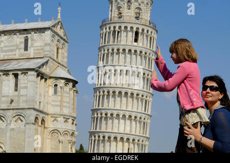 Woman and child supporting the Leaning Tower of Pisa, Pisa, Tuscany, Italy Stock Photo