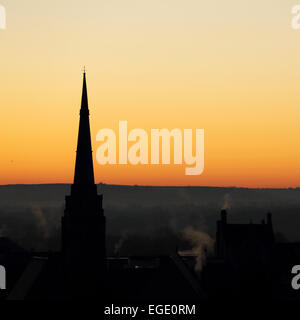 Spire of St Nicholas Church silhouetted against a golden sky in Durham City, England. Stock Photo