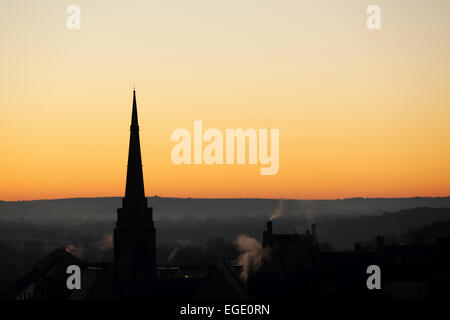 Spire of St Nicholas Church silhouetted against a golden sky in Durham City, England. Stock Photo