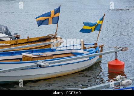 AHUS, SOUTH SWEDEN - JUNE 28, 2014: Two boats with waving Swedish flags in the marina on June 28, 2014 in Ahus, South Sweden. Stock Photo