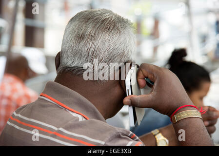 Grey haired man using a mobile phone Stock Photo