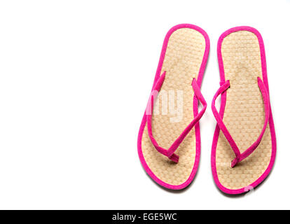 Straw and pink flip-flop sandals on a white background with copy space Stock Photo
