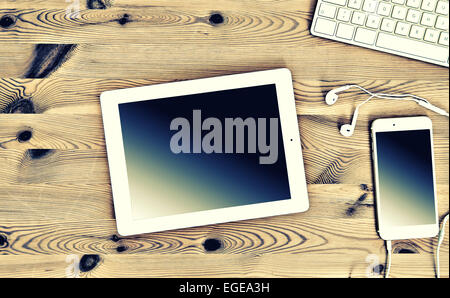 Top View Office Workplace with Keyboard, Tablet PC, Phone. Vintage Instagram style toned picture Stock Photo