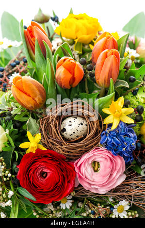 easter bouquet with egg decoration. spring flowers tulip, ranunculus, hyacinth, daisy, anemone Stock Photo