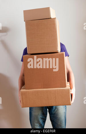 Man Carrying Stacked Boxes on moving day Stock Photo