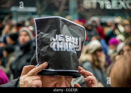 Crying man holding a 'Je suis Charlie' sign, during Montreal silent march in tribute to cartoonists killed in France. Stock Photo