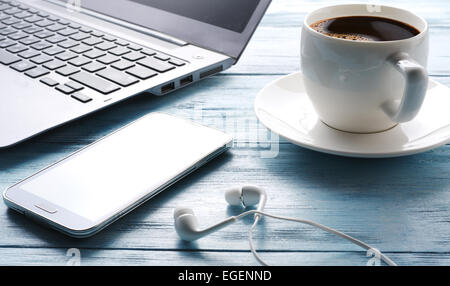 Coffee break. Office table with different gadgets on it. Top view. Stock Photo